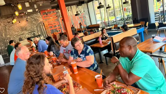 Guests enjoying pizza and conversation at the IEEE Foothill YP Pi Day Mixer